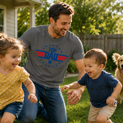 Man wearing a 'Top Dad' on a gray colored t-shirt with two children and a dog in a backyard.