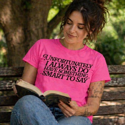 Woman in coral silk colored t-shirt reading a book on a park bench