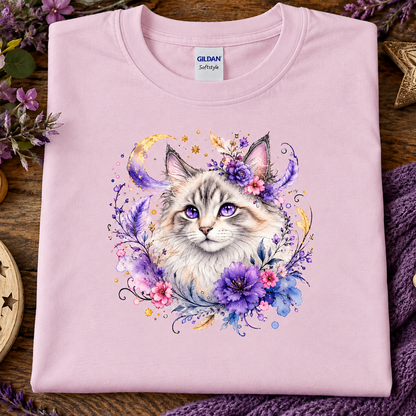 A light pink t-shirt with a silver tabby cat wrapped in colorful flowers graphic.