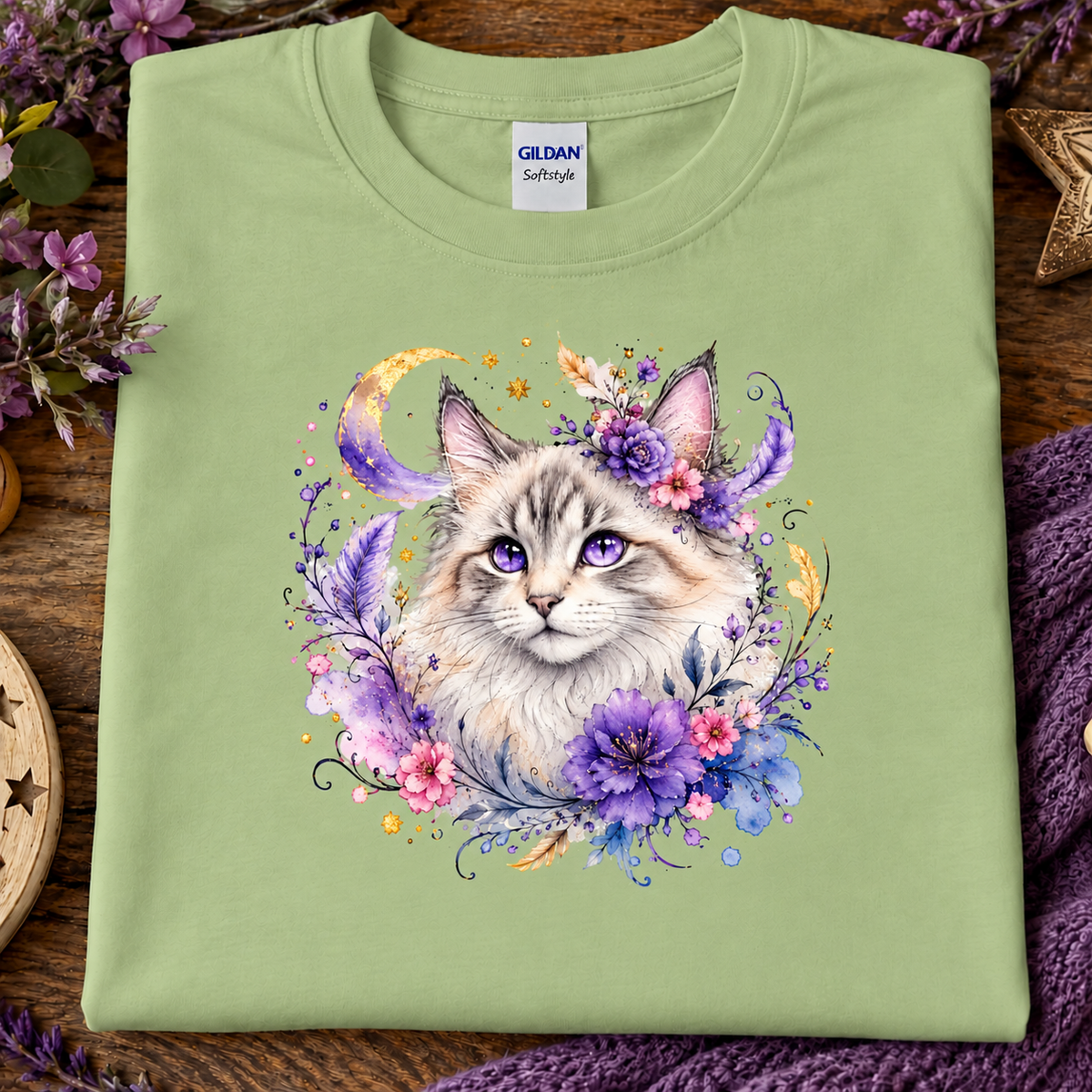 A pistachio green t-shirt with a silver tabby cat wrapped in colorful flowers graphic.