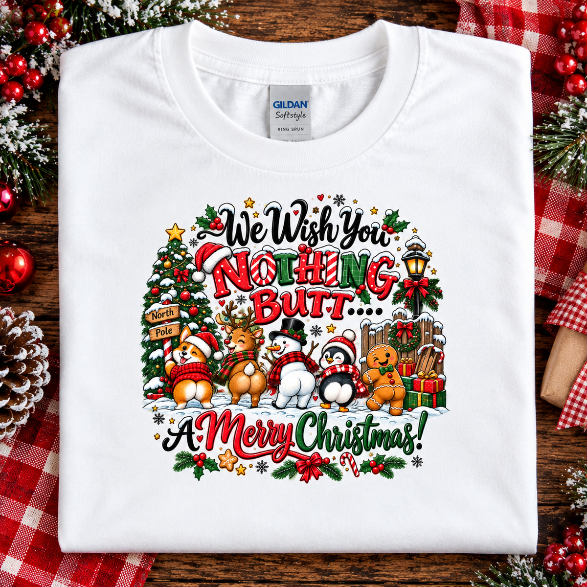 A folded white Gildan Softstyle t-shirt with a colorful Christmas graphic that reads 'We Wish You Nothing Butt.