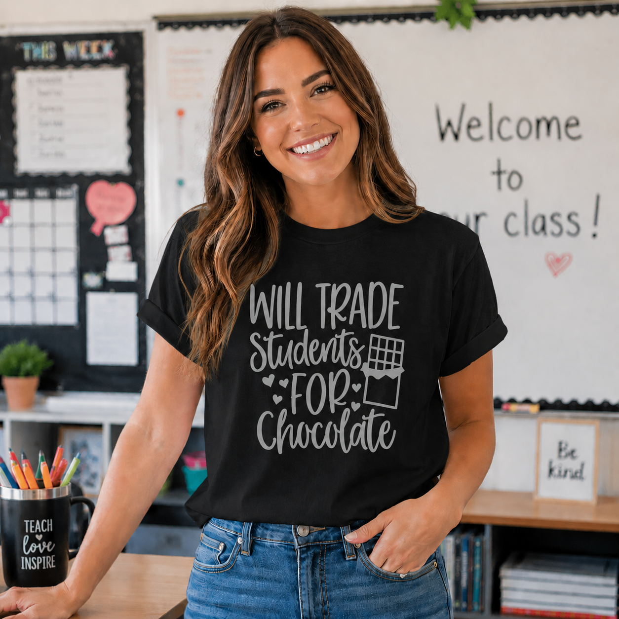 “Will Trade Students for Chocolate” funny teacher text graphic printed on a black t-shirt.