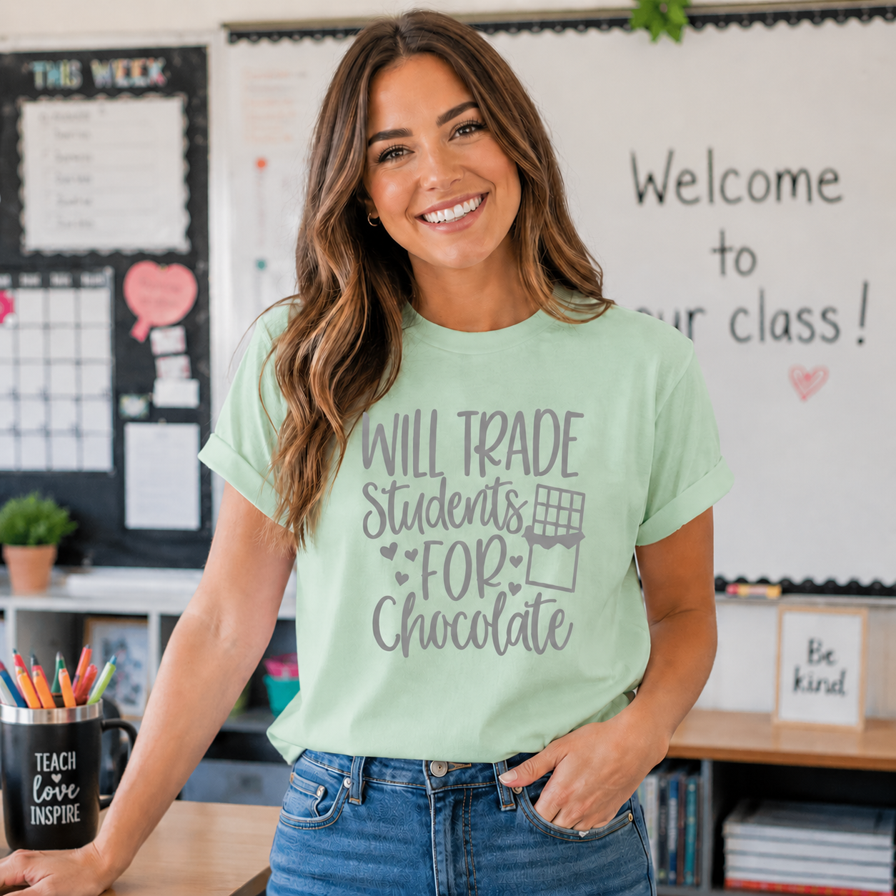 “Will Trade Students for Chocolate” funny teacher text graphic printed on a mint green t-shirt.