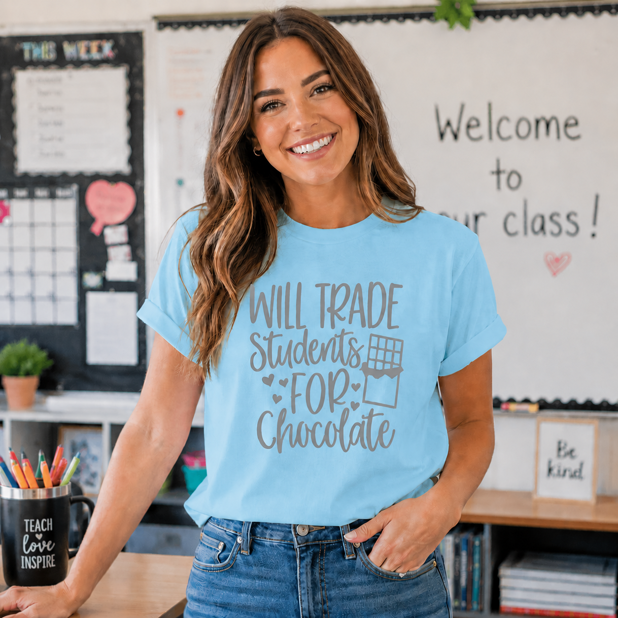 “Will Trade Students for Chocolate” funny teacher text graphic printed on a sky blue t-shirt.