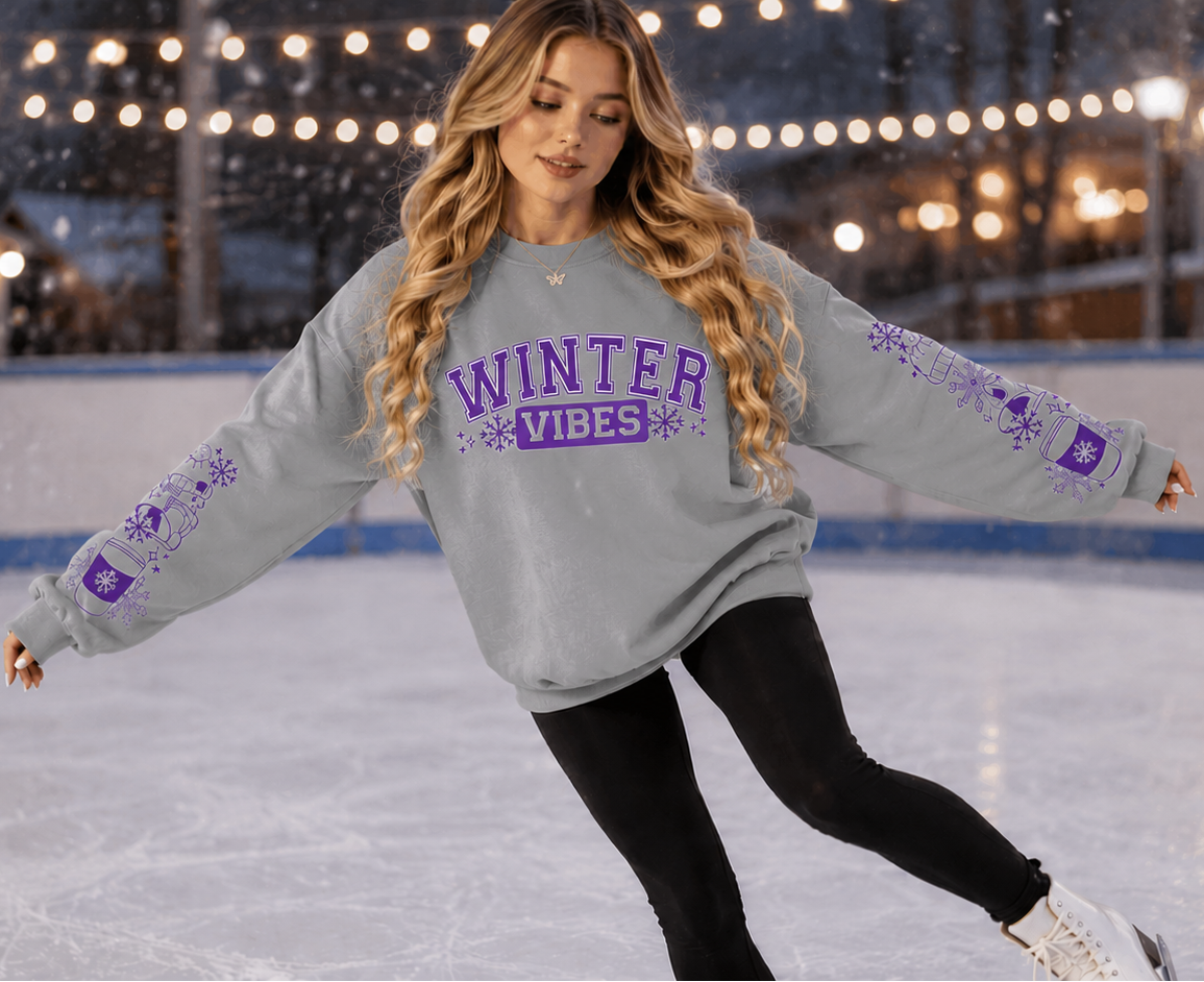Woman wearing a sports gray sweatshirt with Winter Vibes text in Purple with sleeve designs