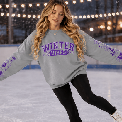 Woman wearing a sports gray sweatshirt with Winter Vibes text in Purple with sleeve designs