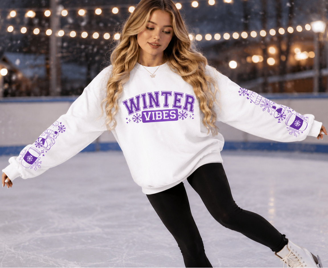 Woman wearing a white sweatshirt with Winter Vibes text in Purple with sleeve designs