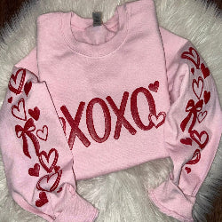 XOXO glitter puff Valentine’s sweatshirt with puff-print hearts and bows on both sleeves