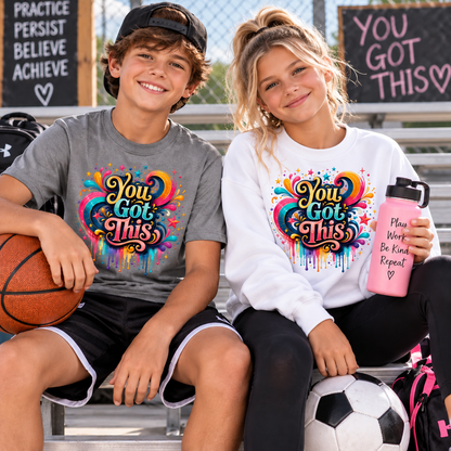 A youth boy with a sport grey graphic t-shirt that says You Got This and a youth girl with a white sweatshirt with the colorful graphic You Got THis