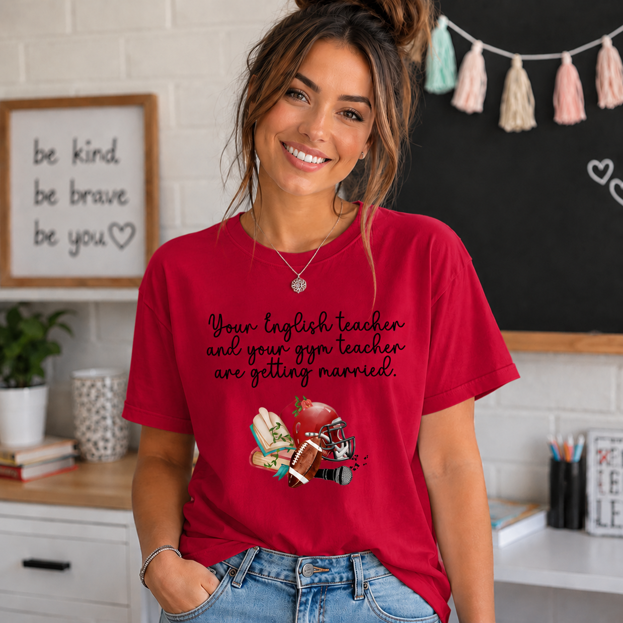 Woman wearing a heather red colored t-shirt with the text Your english teacher and your gym teacher are getting married.
