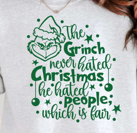White sweatshirt with green Grinch text design on a white background